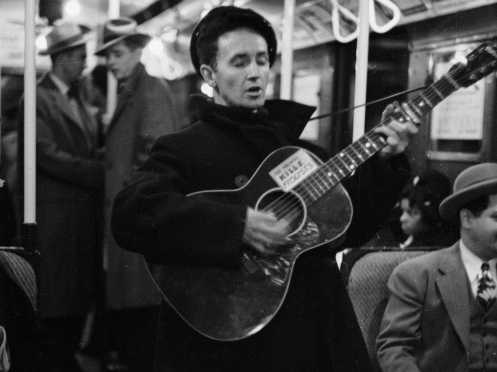 Woody Guthrie singing aboard a New York City subway train.
