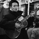 Woody Guthrie singing aboard a New York City subway train. Woody Guthrie singing aboard a New York City subway train.