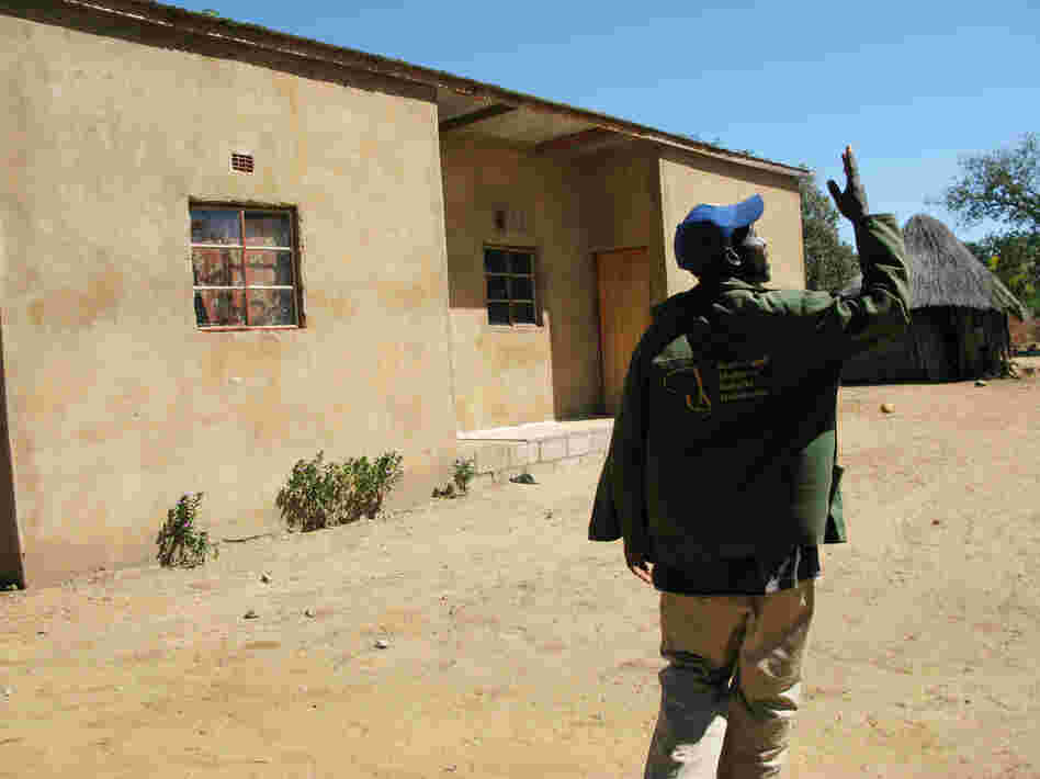 Johane Setlhare began taking anti-AIDS drugs, provided by the government, in 2007. Two years later, he regained enough strength to build the house that's behind him. Johane Setlhare began taking anti-AIDS drugs, provided by the government, in 2007. Two years later, he regained enough strength to build the house that's behind him.