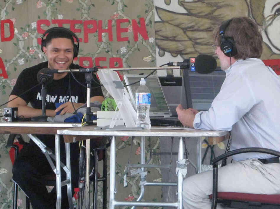 Trevor Noah and Neal Conan share a laugh during the interview.