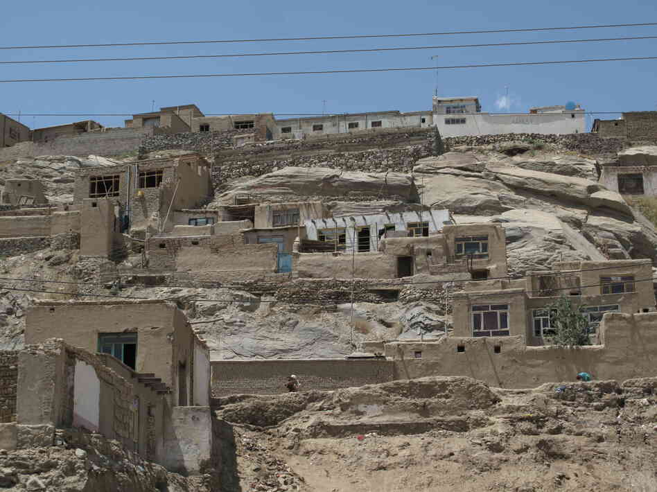 Poorly constructed houses cling precariously to hillsides in Kabul. Such neighborhoods often lack electricity and running water.