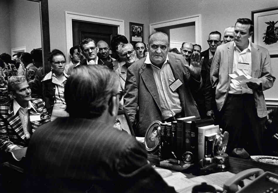 Disabled coal miners and widows confront their Kentucky congressman's poor record of supporting black lung legislation in Washington, D.C., in 1975.