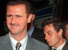 Then-Col. Bashar Assad (left) and Manaf Tlass in 1999. Tlass, now a brigadier general, has reportedly defected and is headed to France. Then-Col. Bashar Assad (left) and Manaf Tlass in 1999. Tlass, now a brigadier general, has reportedly defected and is headed to France.