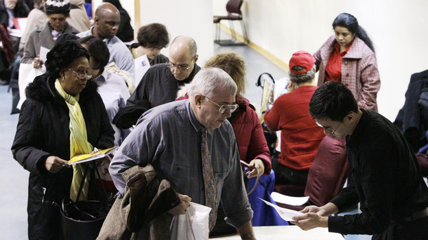 John Pham (right) reviews Bob Drake's resume at an AARP event aimed at helping older workers improve their job search. Workers age 55 and older cite particular difficulty finding employment, and some are choosing to retrain for new careers.