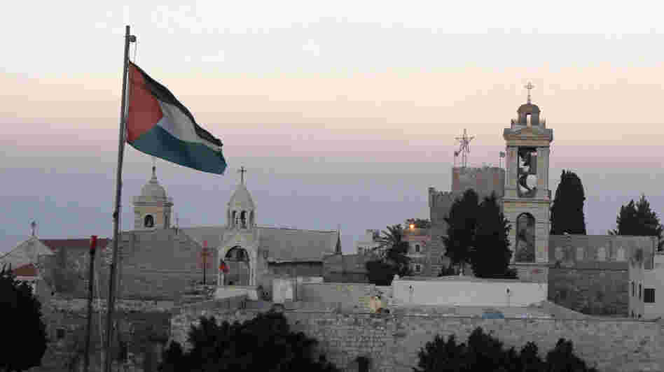 The Palestinian flag flutters in front of the Church of the Nativity in the biblical West Bank town of Bethlehem on June 29. UNESCO has given the site World Heritage status.