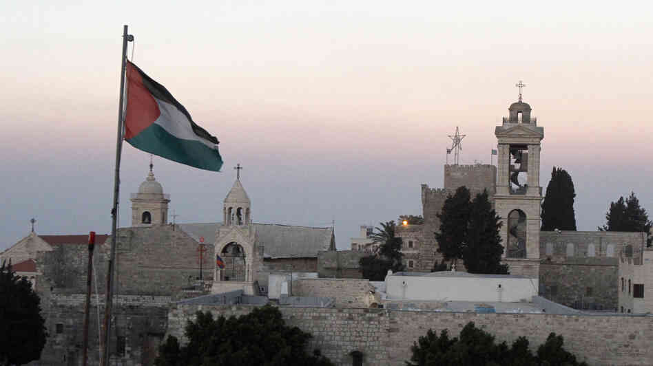 The Palestinian flag flutters in front of the Church of the Nativity in the biblical West Bank town of Bethlehem on June 29. UNESCO has given the site World Heritage status.