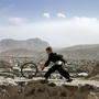 An Afghan boy pushes a wheel on the Naderkhan hill in Kabul, Afghanistan, in May. As more people have crowded to Kabul, the city center has become like a buoy floating in a sea of sprawl. An Afghan boy pushes a wheel on the Naderkhan hill in Kabul, Afghanistan, in May. As more people have crowded to Kabul, the city center has become like a buoy floating in a sea of sprawl.