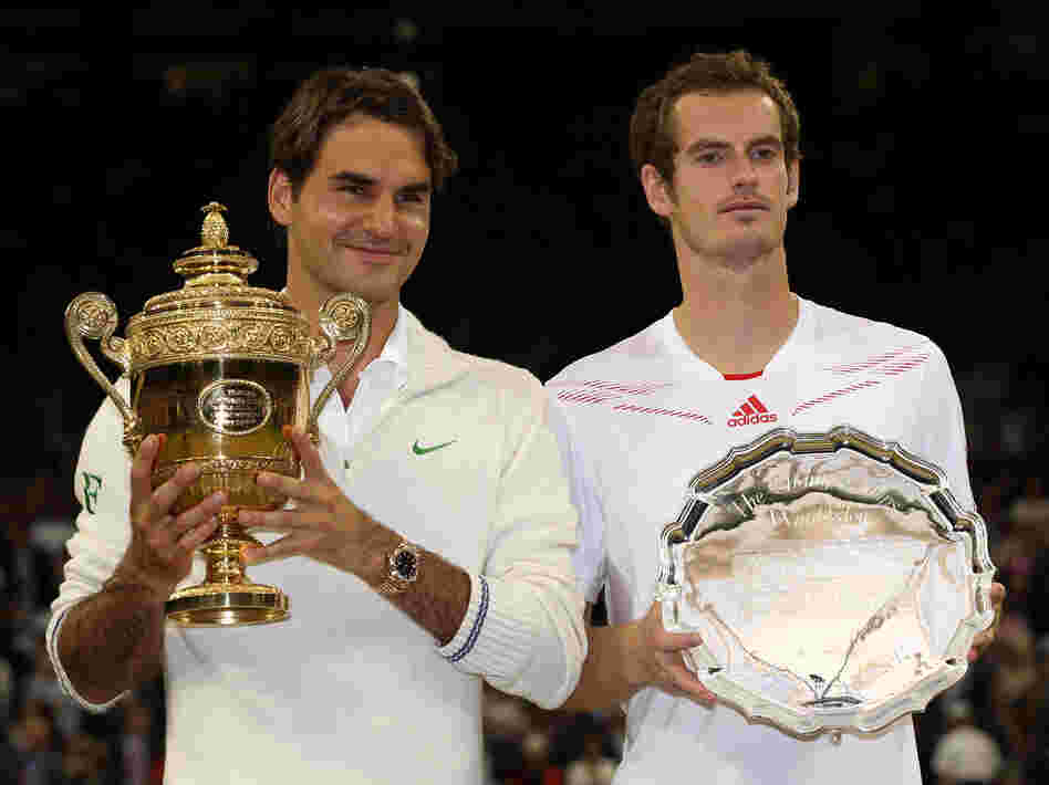 Roger Federer of Switzerland (left) and Andy Murray of Great Britain hold up their trophies after the men's singles final match at Wimbledon Sunday. Roger Federer of Switzerland (left) and Andy Murray of Great Britain hold up their trophies after the men's singles final match at Wimbledon Sunday.