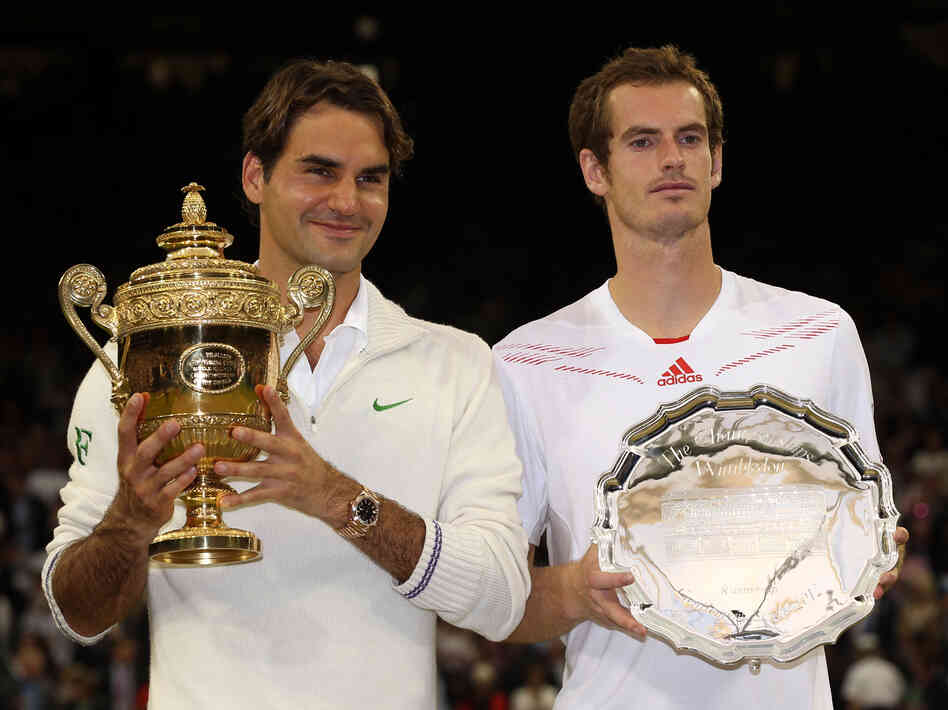 Roger Federer of Switzerland (left) and Andy Murray of Great Britain hold up their trophies after the men's singles final match at Wimbledon Sunday. Roger Federer of Switzerland (left) and Andy Murray of Great Britain hold up their trophies after the men's singles final match at Wimbledon Sunday.