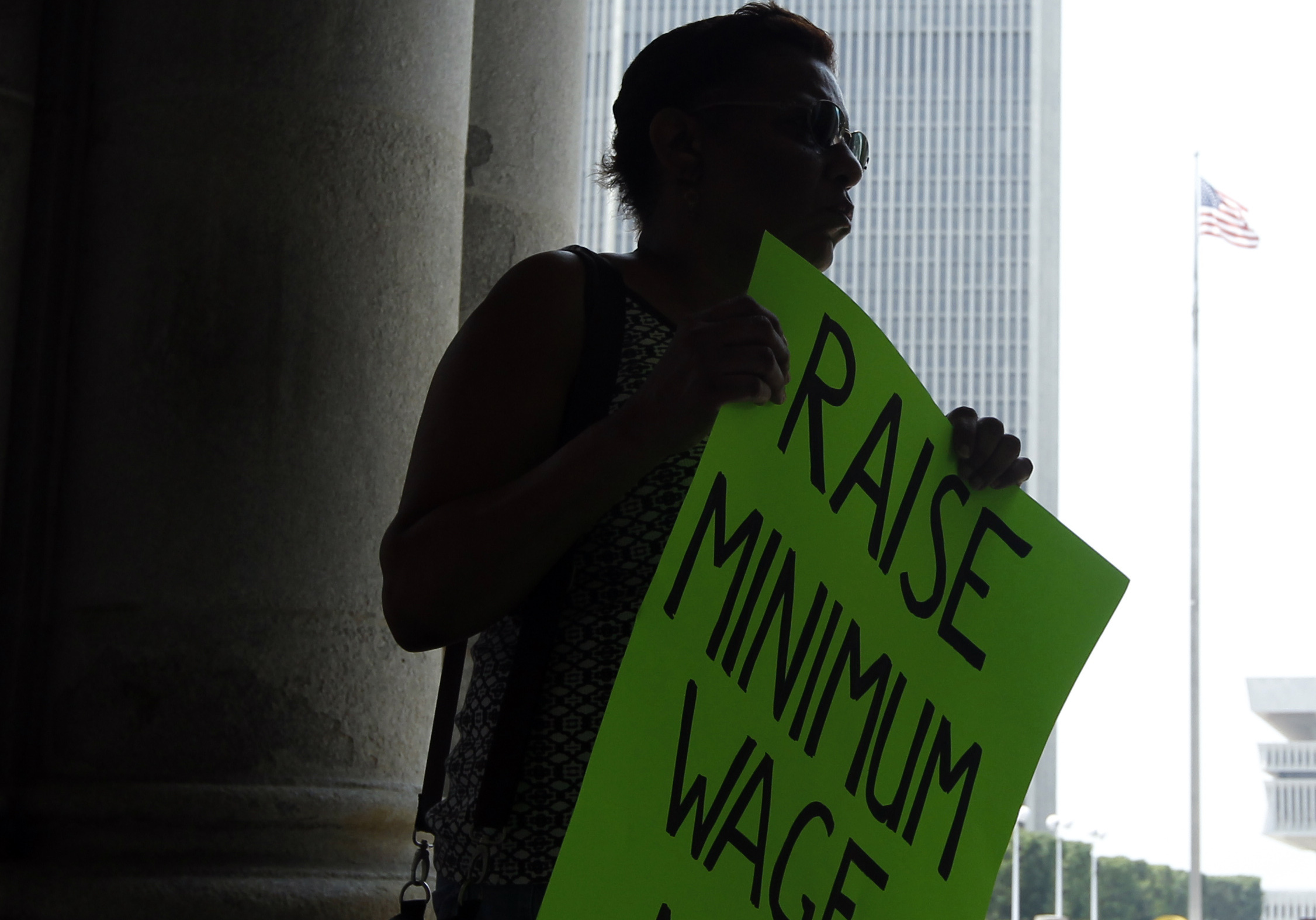 Wendy Brown of Schenectady, N.Y., holds a sign before an Occupy Albany rally pushing for a raise in New York's minimum wage on May 29, 2012.