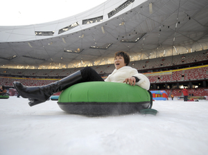 A woman goes snow-tubing in January 2010 inside the Bird's Nest, which was transformed temporarily into a winter theme park. A woman goes snow-tubing in January 2010 inside the Bird's Nest, which was transformed temporarily into a winter theme park.