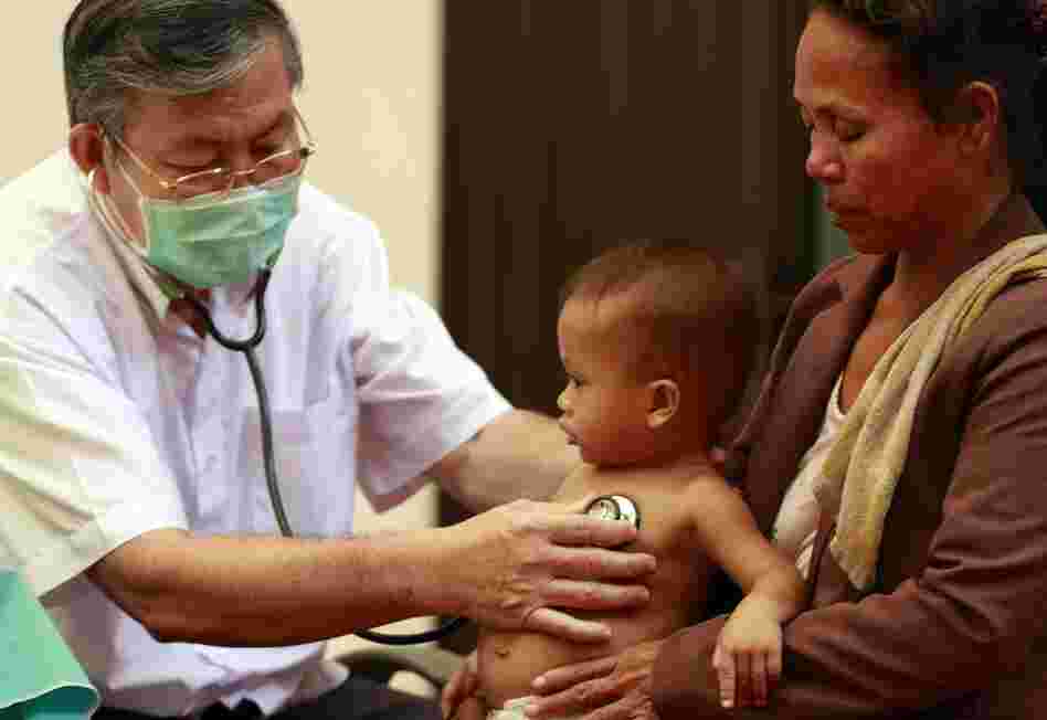 A Cambodian doctor examines a child at Kantha Bopha Children's Hospital in Phnom Penh.
