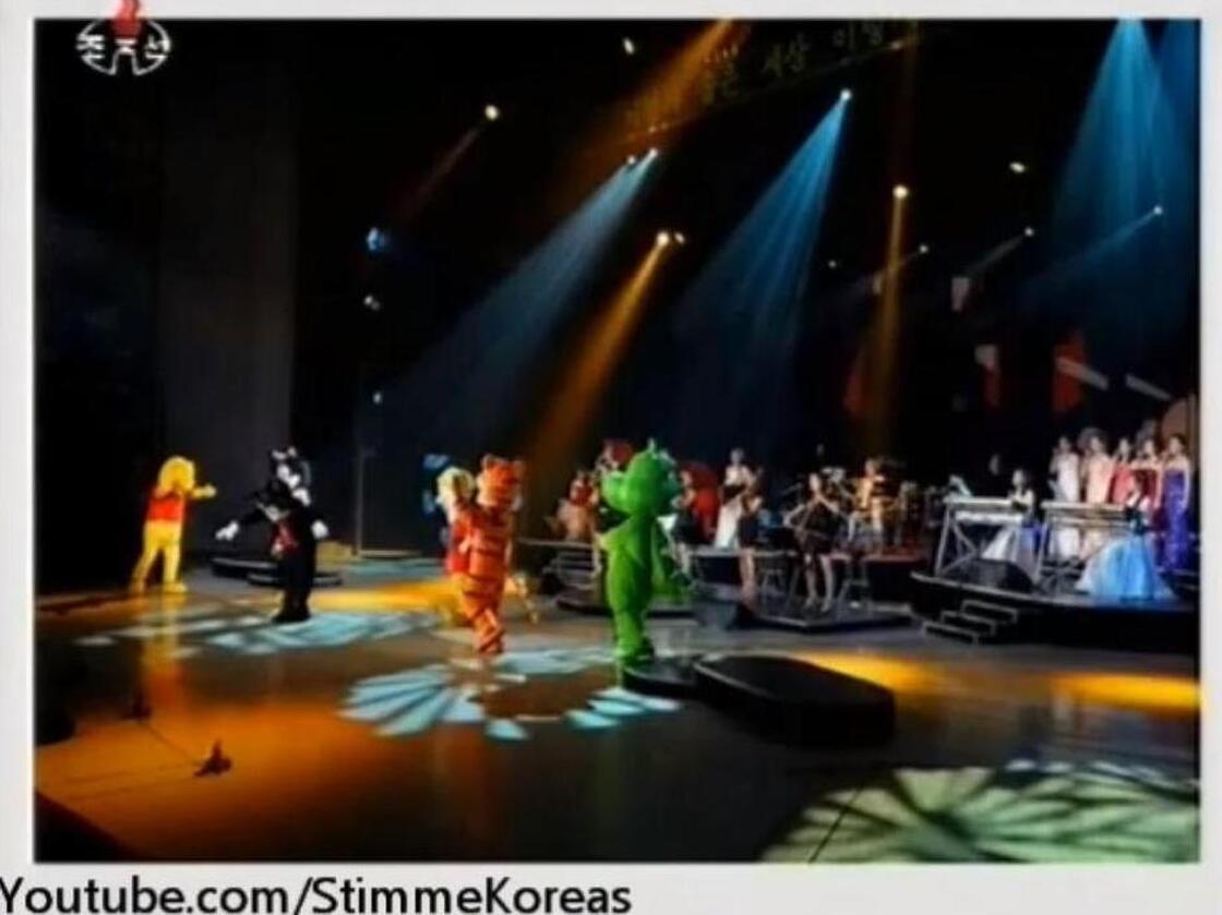 An image from a video posted by StimmeKoreas, which in turn came from North Korea official media, showing some of the dancing (fake) Disney characters at Friday's performance.