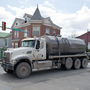 A water tank truck is seen on the main street in Waynesburg, Pa., on April 13. Scientists say naturally polluted water can rise to the surface of the Marcellus Shale; that finding suggests that frack water could seep out, too.