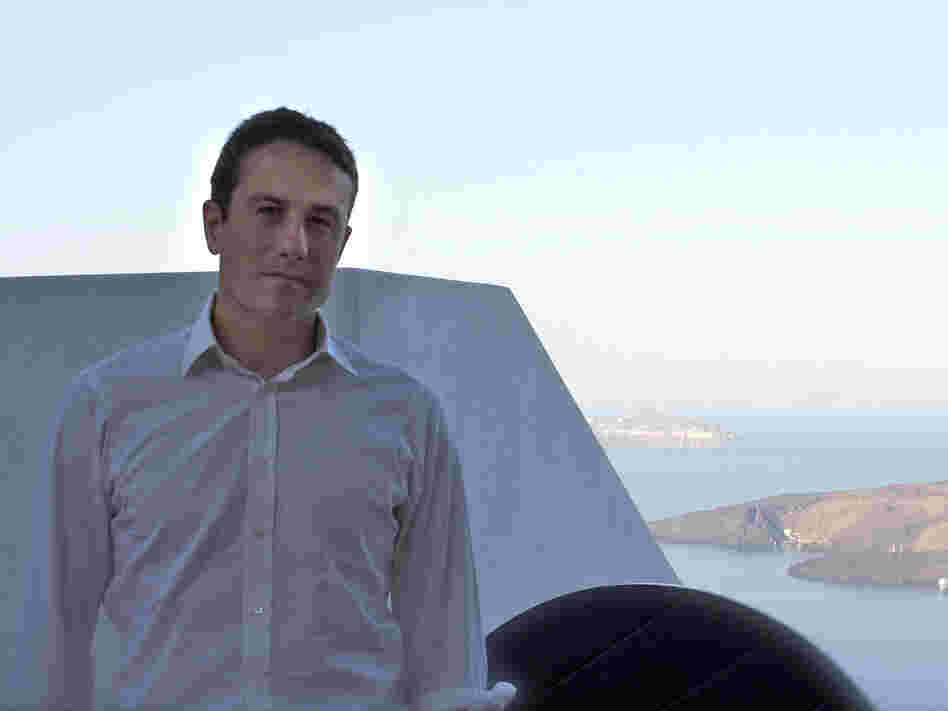 Peter Nomikos, who founded the charity Greece Debt Free about two weeks ago, sits outside the Santozeum, a family museum in Thira town, Santorini. Peter Nomikos, who founded the charity Greece Debt Free about two weeks ago, sits outside the Santozeum, a family museum in Thira town, Santorini.