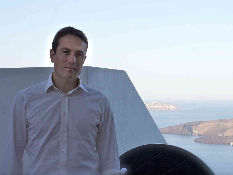 Peter Nomikos, who founded the charity Greece Debt Free about two weeks ago, sits outside the Santozeum, a family museum in Thira town, Santorini. Peter Nomikos, who founded the charity Greece Debt Free about two weeks ago, sits outside the Santozeum, a family museum in Thira town, Santorini.