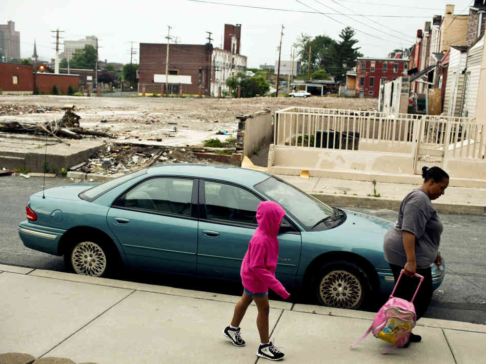 Tracy Boggs, 49, walks her daughter Emily, 7, to the Second Street Learning Center in Reading, Pa.