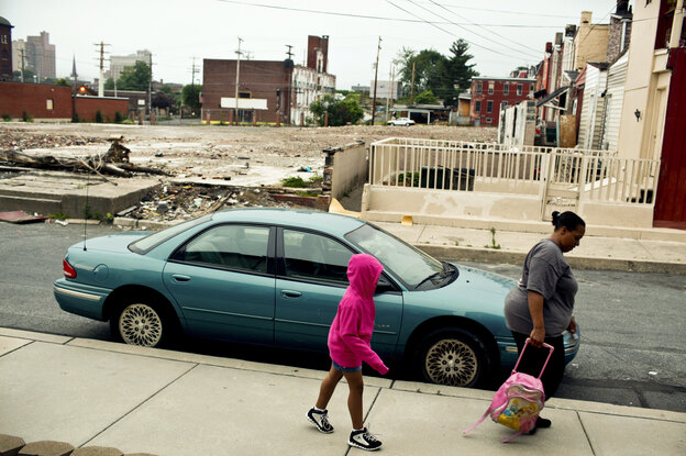 Tracy Boggs, 49, walks her daughter Emily, 7, to the Second Street Learning Center in Reading, Pa.