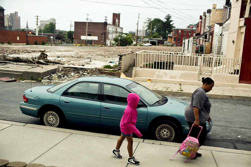 Tracy Boggs, 49, walks her daughter Emily, 7, to the Second Street Learning Center in Reading, Pa.