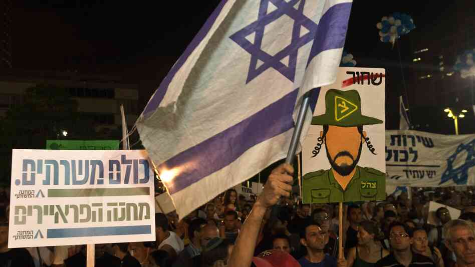 Israeli reservists soldiers and Israeli parents whose children were killed during army service attend a rally in support of a new law to mandate universal military conscription — including ultra-religious Jews who had been previously exempt and Arab Israelis, July 7, in Tel Aviv, Israel.