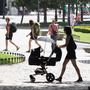 A woman pushes a pram though the Plaza de Murillo on July 3 in Madrid. Spain's custom for multiple families to live under the same roof has tied them closer together as well as their wallets. The country has the highest unemployment rate in the Eurozone, and government benefits help aid those out of work.