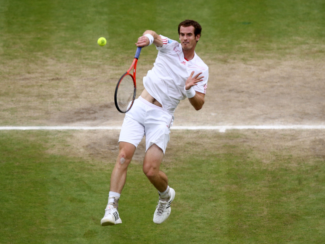 Andy Murray returns a shot during the men's final match at Wimbledon. A pair of tickets for the match went for £32,000 (about $50,000).