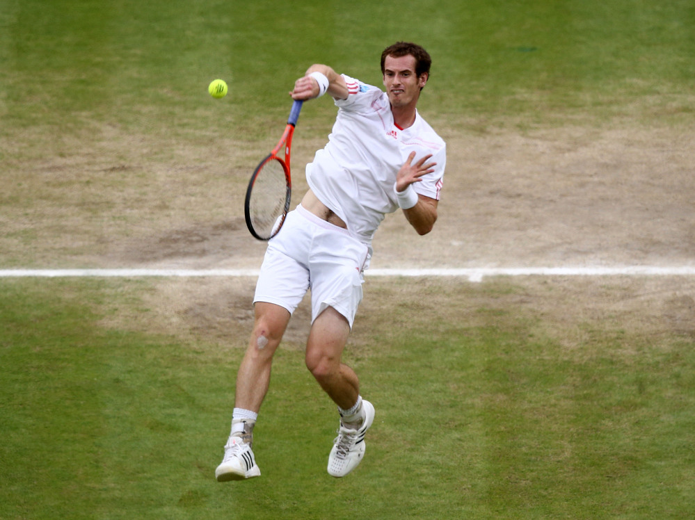 Andy Murray returns a shot during the men's final match at Wimbledon. A pair of tickets for the match went for £32,000 (about $50,000).