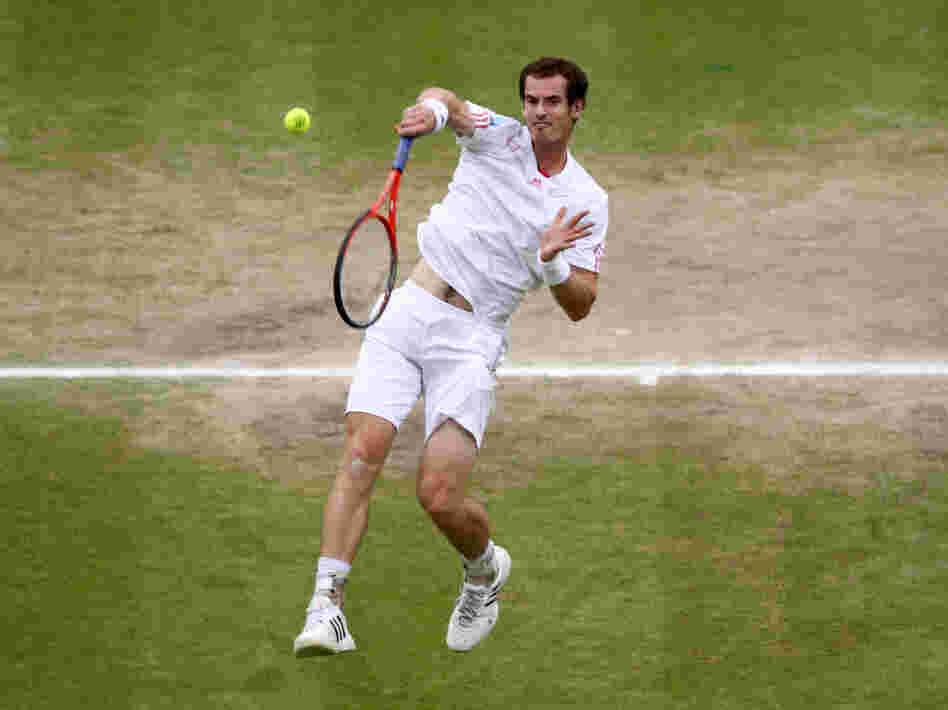 Andy Murray returns a shot during the men's final match at Wimbledon. A pair of tickets for the match went for £32,000 (about $50,000).