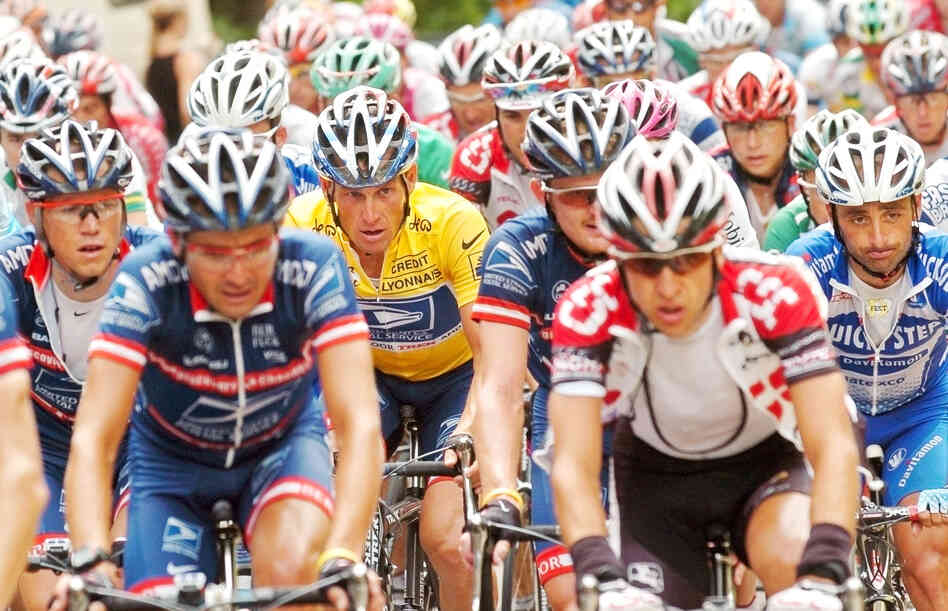 Lance Armstrong, rear left in yellow jersey, rides in the pack flanked by his US Postal Service teammates during the 18th stage of the Tour de France in 2004.