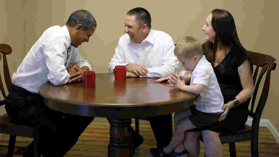 President Obama meets with Jason and Ali McLaughlin and their son, Cooper, while visiting their home in Cedar Rapids, Iowa.
