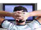 A young adult watching TV.