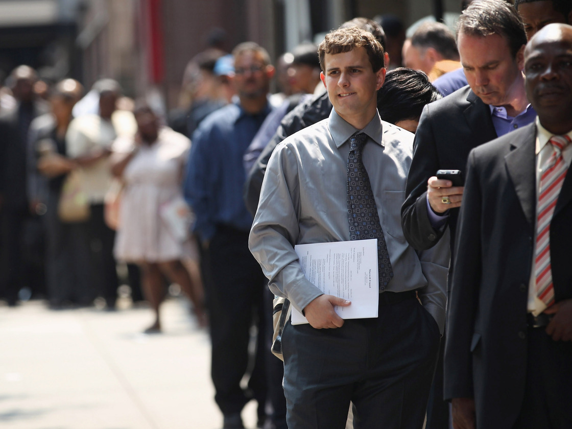 Applicants wait to enter a job fair in New York City last month.