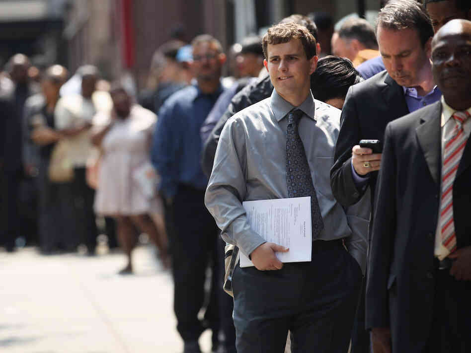 Applicants wait to enter a job fair in New York City last month.