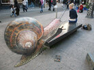 A snail on a city bench. A snail on a city bench.