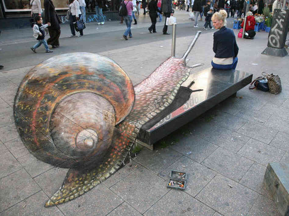 A snail on a city bench.
