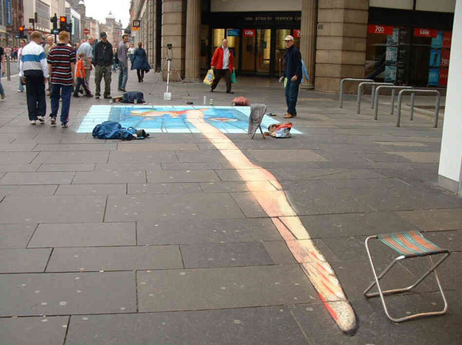 A pavement drawing of a woman in a pool viewed from the wrong angle.