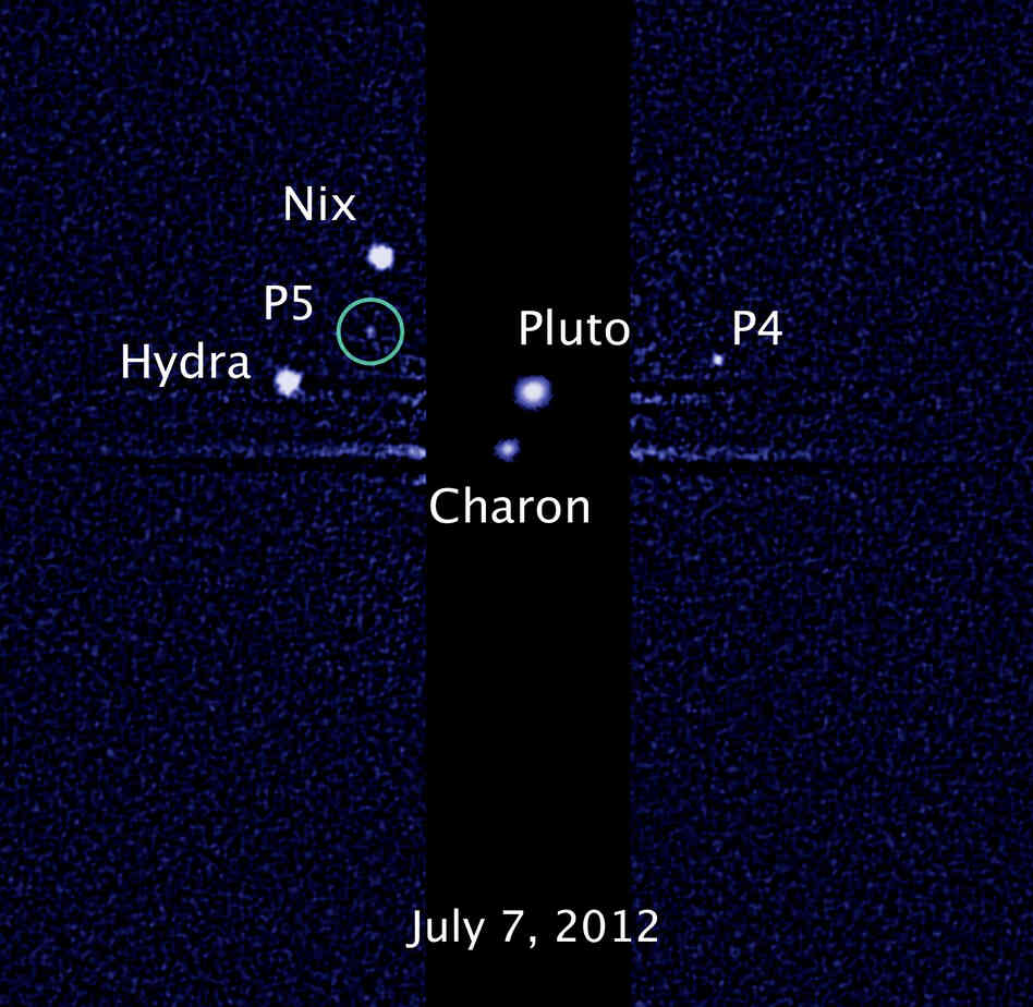 This image, taken by NASA's Hubble Space Telescope, shows five moons orbiting the distant, icy dwarf planet Pluto. The green circle marks the newly discovered moon, designated P5.