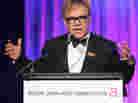 Sir Elton John speaks at an Elton John AIDS Foundation benefit in 2010. The organization, which John founded in 1992, provides grants to support HIV and AIDS prevention and treatment programs.