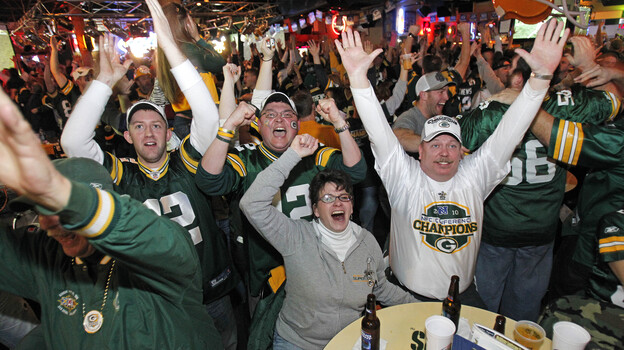 Will these Green Bay fans be cheering as much as they did during the 2011 Super Bowl when their beloved Packer games are interrupted by local political ads this fall?