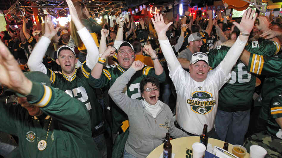 Will these Green Bay fans be cheering as much as they did during the 2011 Super Bowl when their beloved Packer games are interrupted by local political ads this fall?
