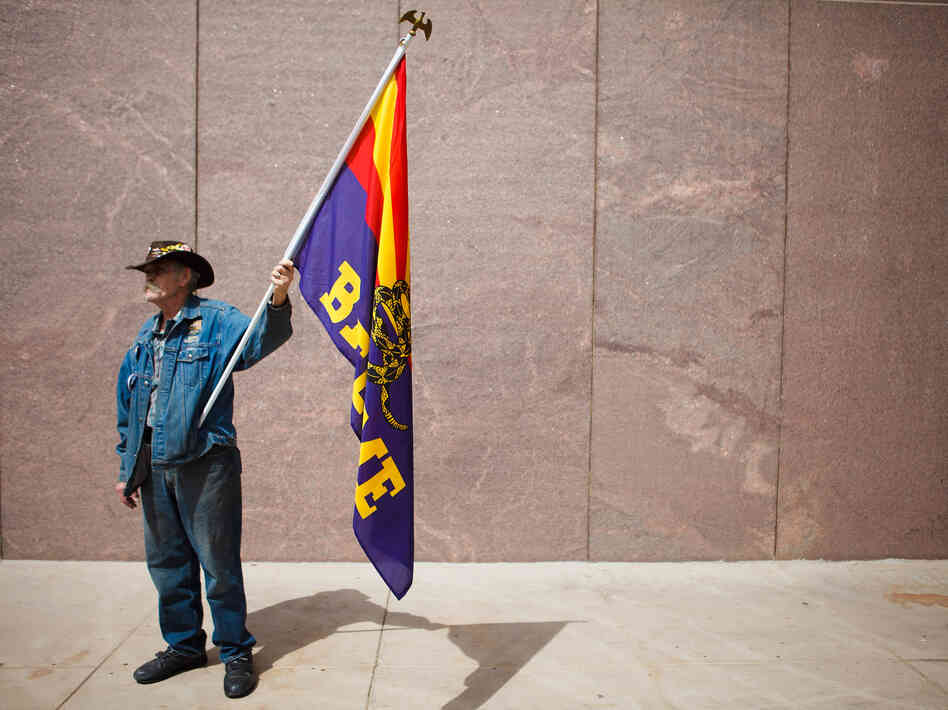 A Tea Party activist rallies in support of Arizona's tough immigration law in Phoenix in April. A Tea Party activist rallies in support of Arizona's tough immigration law in Phoenix in April.