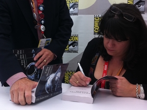 E.L. James signs copies of her book Fifty Shades of Grey at Comic-Con in San Diego on Thursday.
