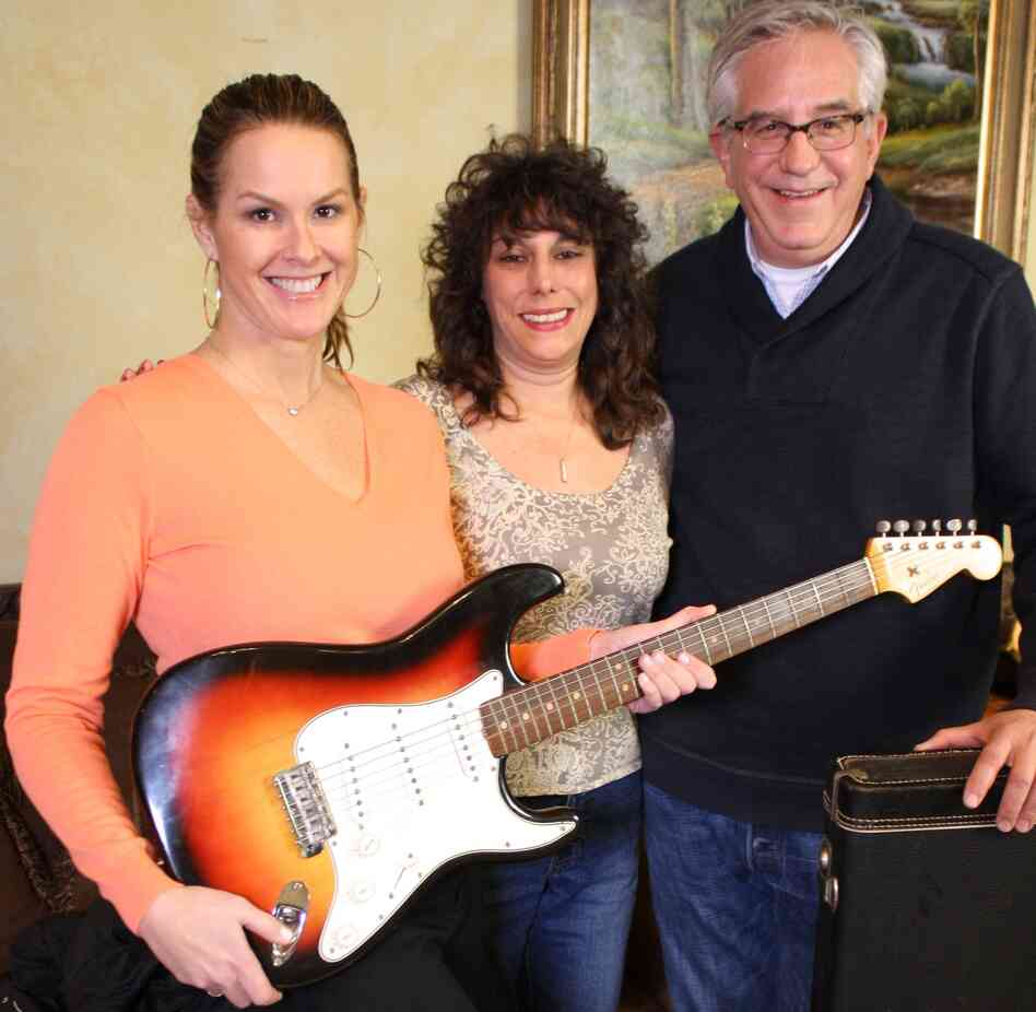 History Detectives' Elyse Luray (left) and Wes Cowan (right), with Dawn Peterson and the guitar Bob Dylan may or may not have played in '65. Peterson says her father came into possession of the famous instrument.