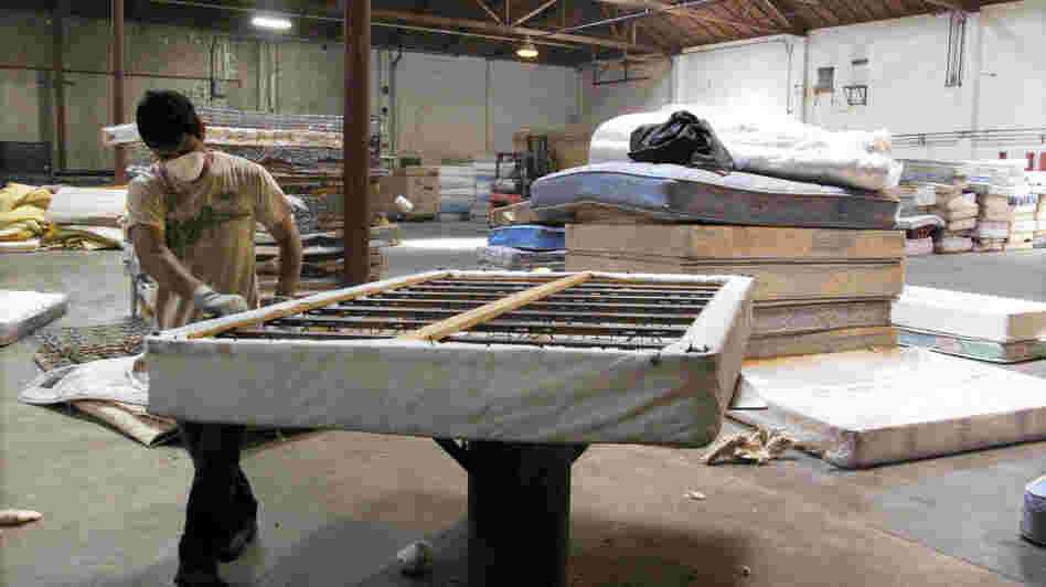 A worker dismantles a mattress at a recycling facility in Oakland, Calif. The material will be used to make carpet products and proceeds will help support the St. Vincent de Paul Society of Lane County, a nonprofit that helps low-income families in Eugene, Ore.
