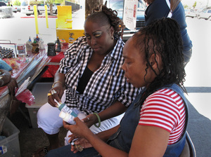 Yovanda Dixon (left) shows fellow group member Pamela Travis some of the bath oils she sells outside a San Francisco grocery store as part of her business Scentuality. Yovanda Dixon (left) shows fellow group member Pamela Travis some of the bath oils she sells outside a San Francisco grocery store as part of her business Scentuality.
