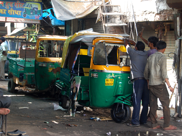 The three-wheeled buggies — a kind of shared taxi — are the most convenient and cheapest way to get around in India. Here, rickshaws are fixed up in New Delhi, India's capital.