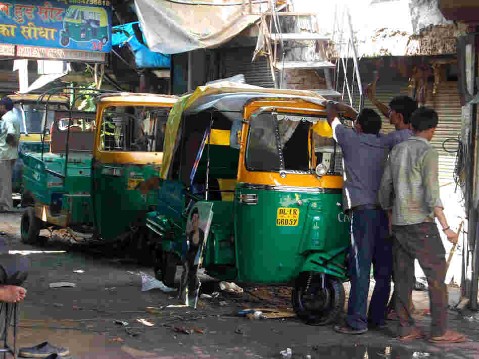 The three-wheeled buggies — a kind of shared taxi — are the most convenient and cheapest way to get around in India. Here, rickshaws are fixed up in New Delhi, India's capital.