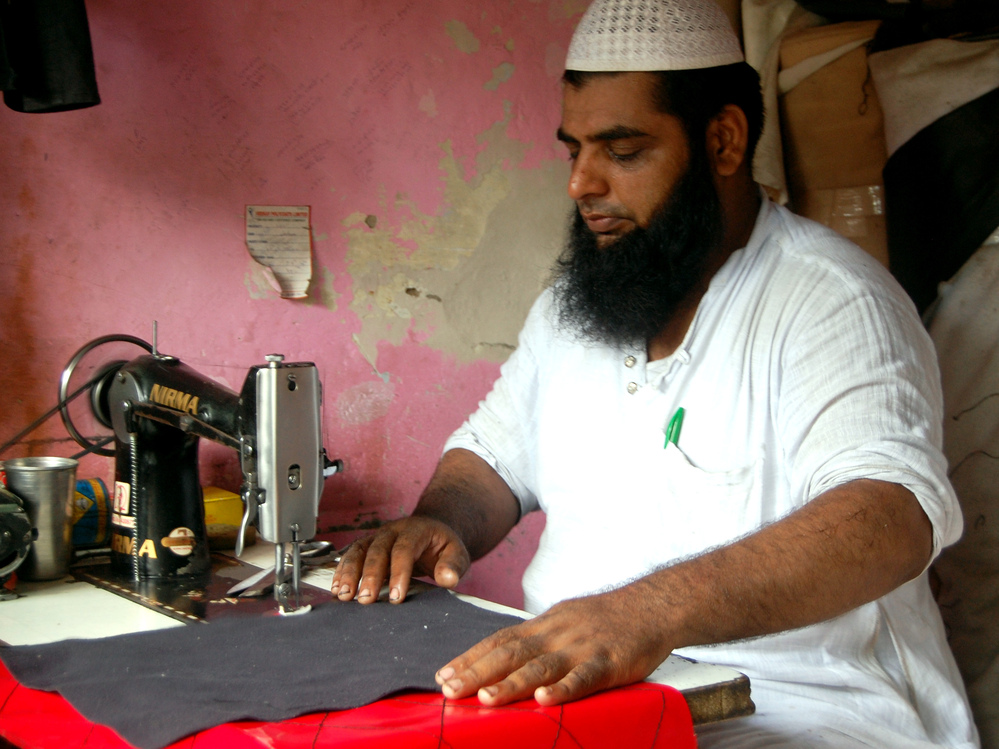 Mohammed Arif makes custom rickshaw seat covers at a market in Delhi that serves as a one-stop shop for the city's rickshaw drivers.