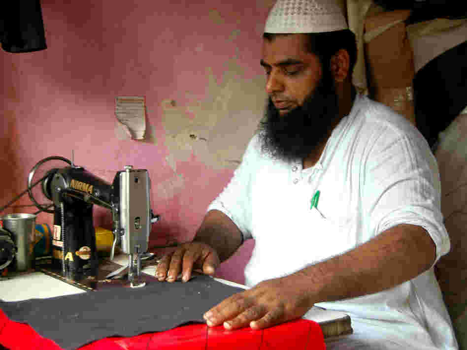 Mohammed Arif makes custom rickshaw seat covers at a market in Delhi that serves as a one-stop shop for the city's rickshaw drivers.