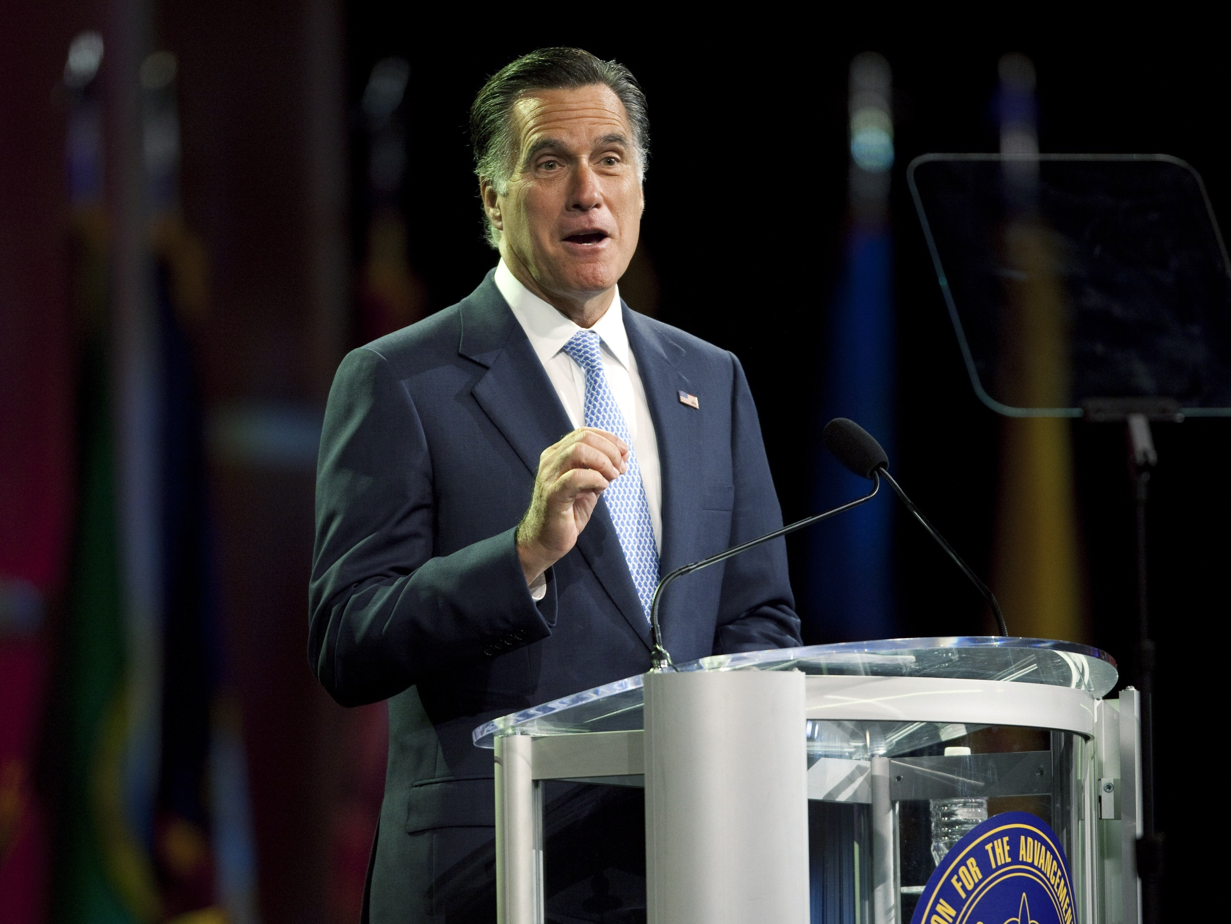 Republican presidential candidate Mitt Romney addresses the NAACP National Convention on July 11 in Houston, Texas. Romney was booed by the audience when he reiterated his commitment to repeal the Affordable Care Act. (Image credit: Getty Images)